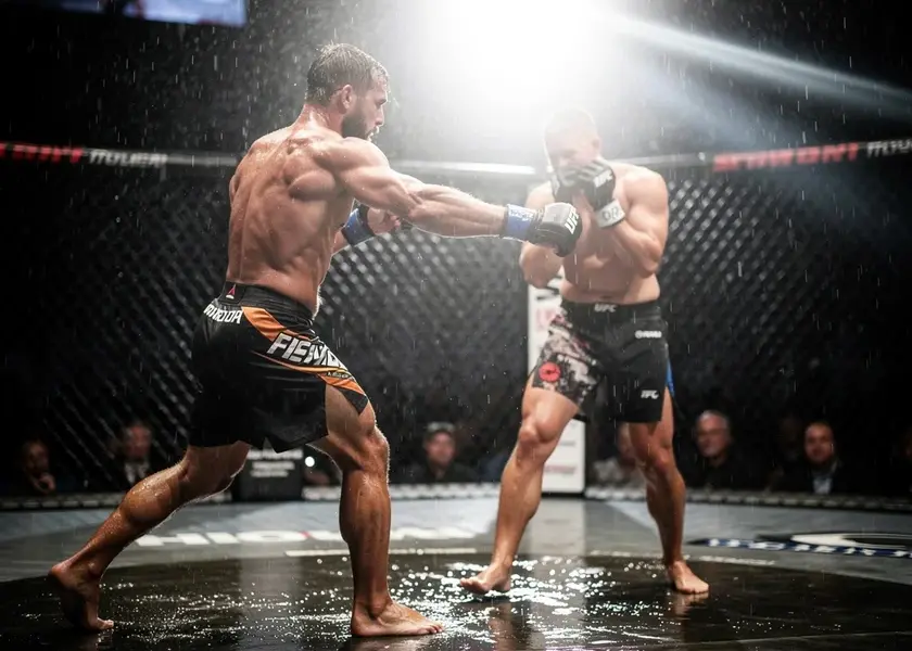 Petr Yan in UFC octagon throwing a left hook during a bantamweight title fight in 2026