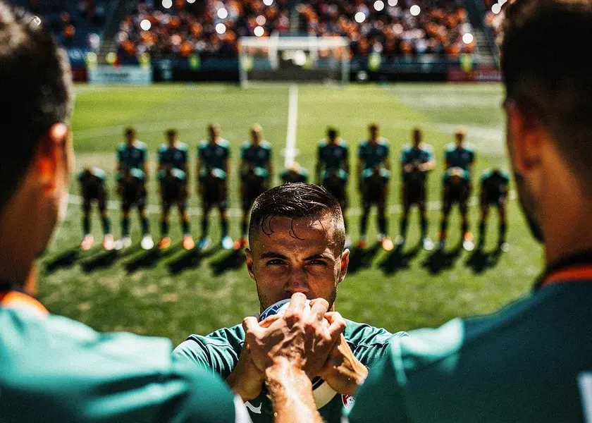 Virgil van Dijk in Liverpool red commanding the penalty area during a Premier League match at Anfield