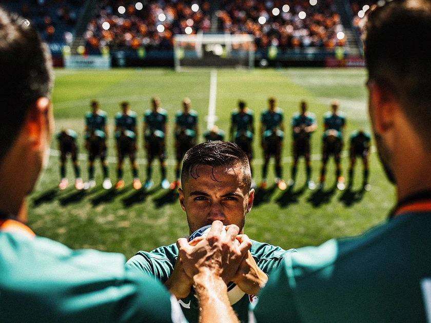 Virgil van Dijk in Liverpool red commanding the penalty area during a Premier League match at Anfield