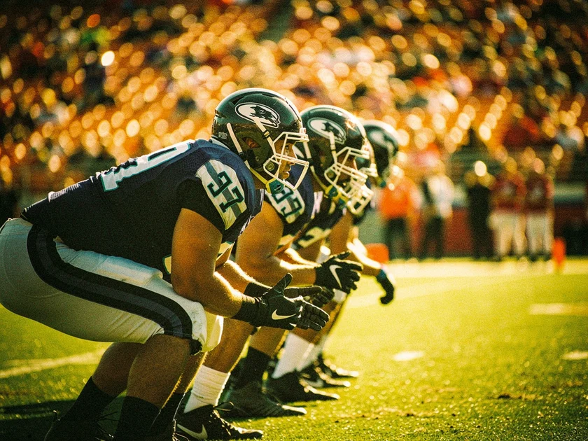 Manchester City and Arsenal players contesting possession in the Premier League Title Race at the Etihad Stadium